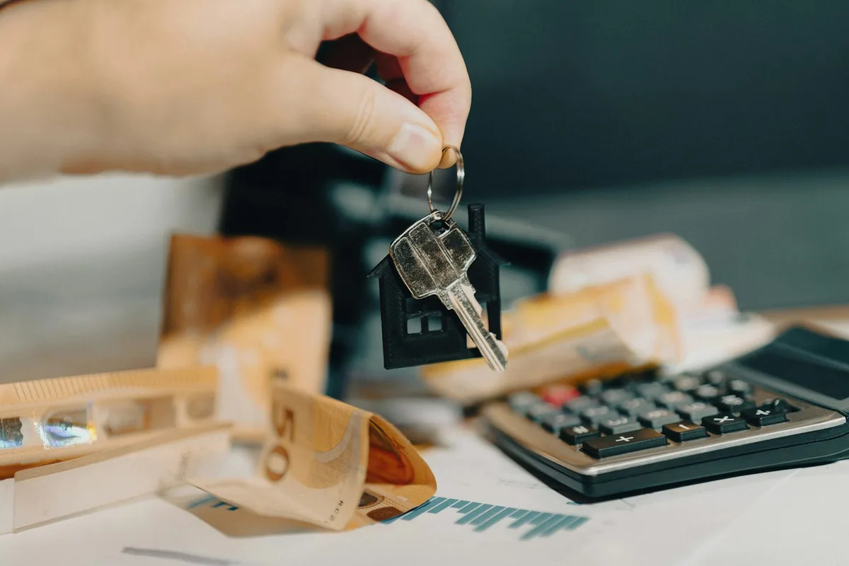 Person reviewing home loan refinance documents with calculator