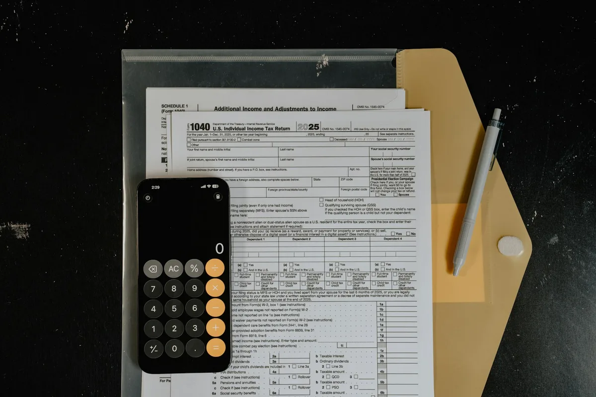 Calculator resting on financial documents representing tax refund calculations