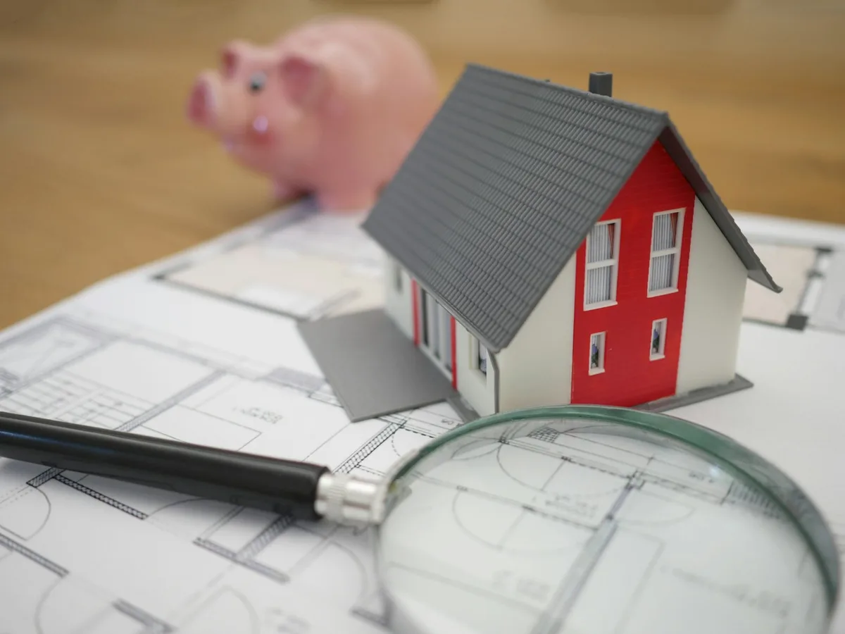 Calculator and loan paperwork on a desk for reviewing investment property finances