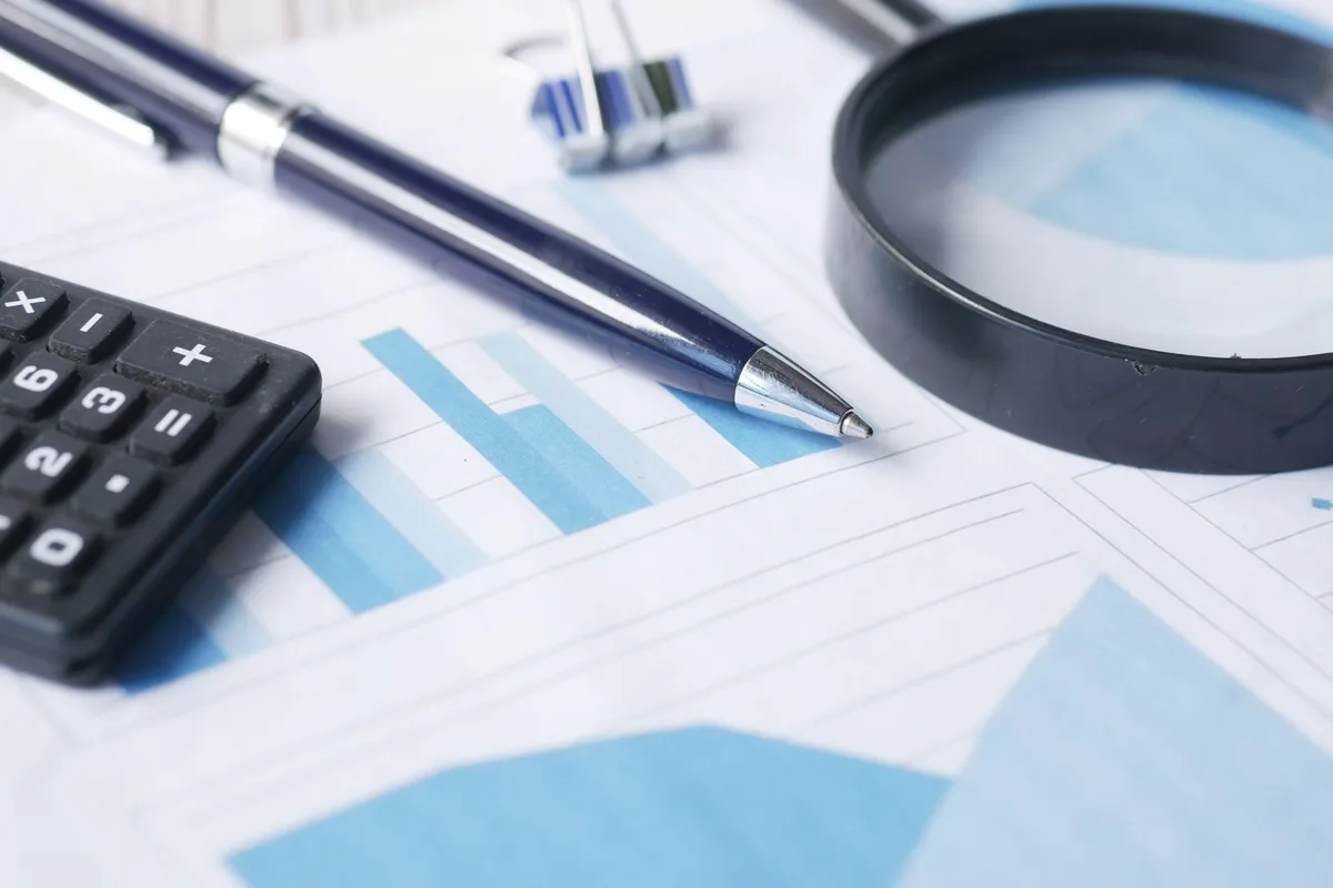 Calculator resting on financial documents for home loan comparison