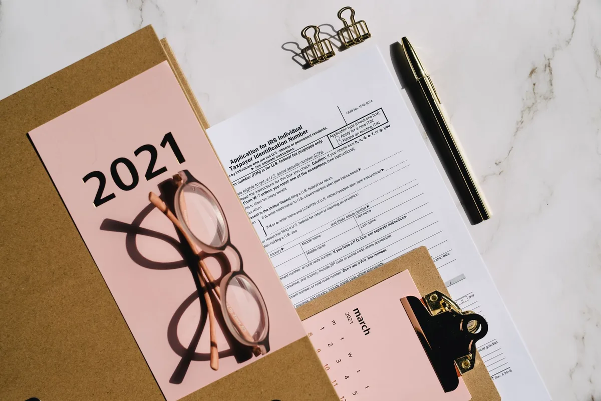 close-up of tax paperwork and documents with a pen on a desk