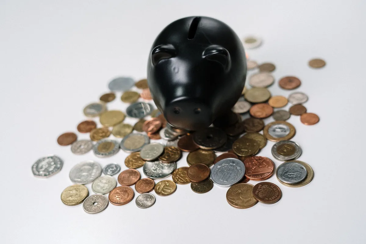 Piggy bank with coins representing stamp duty savings for first home buyers