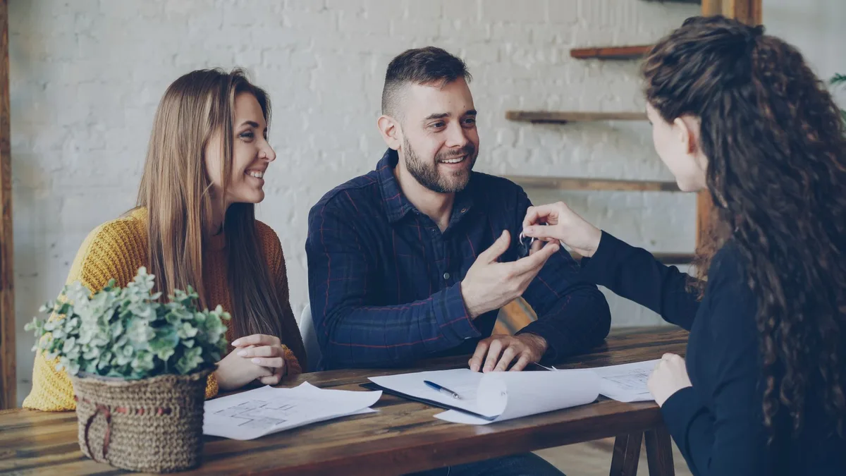Couple holding keys to their new home after securing a low-deposit home loan
