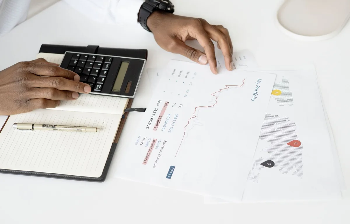 Calculator resting on financial documents showing loan calculations