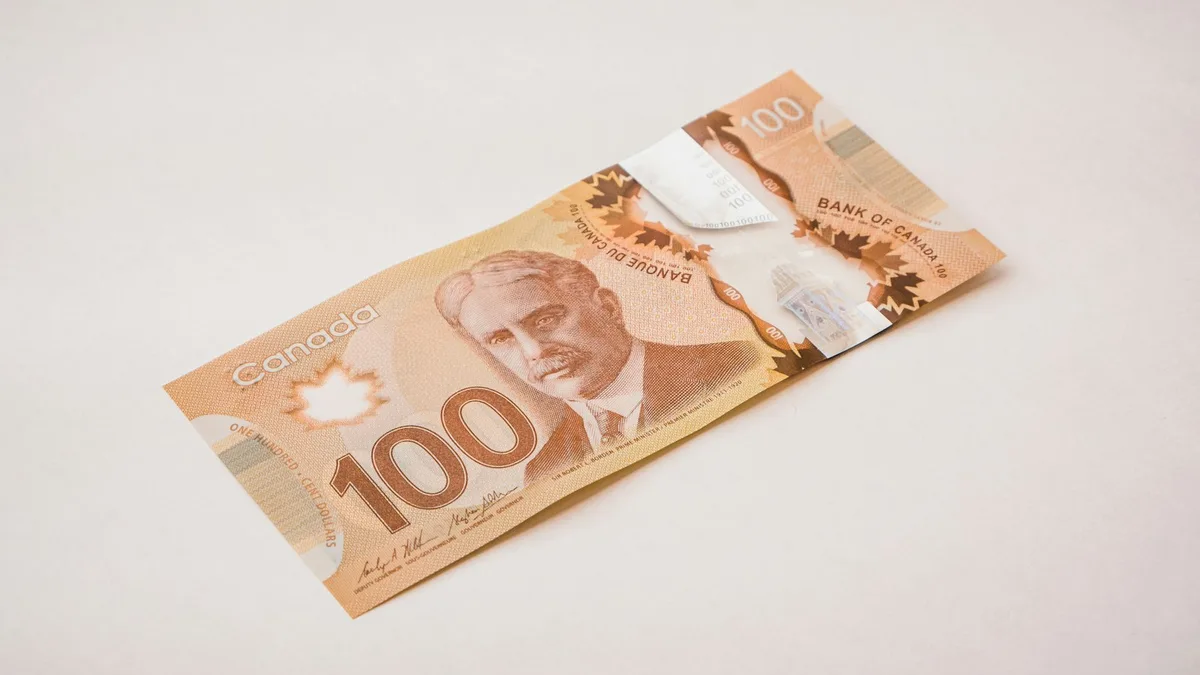 Canadian dollar bills representing interest rate policy decisions