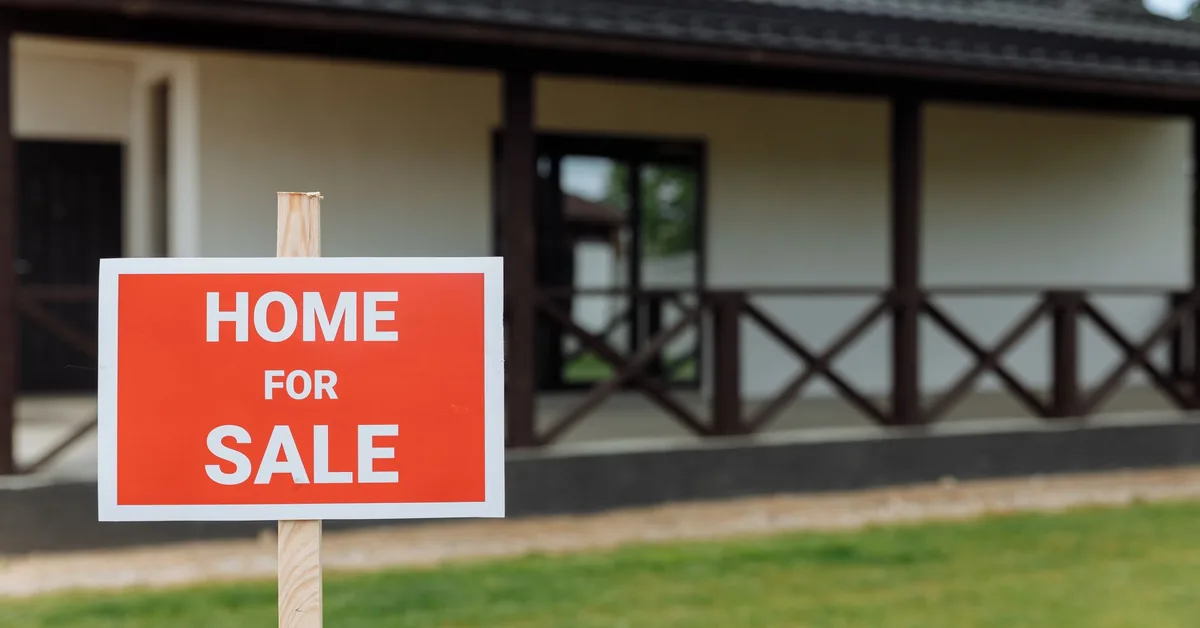 A Canadian-style for-sale sign outside a residential home.