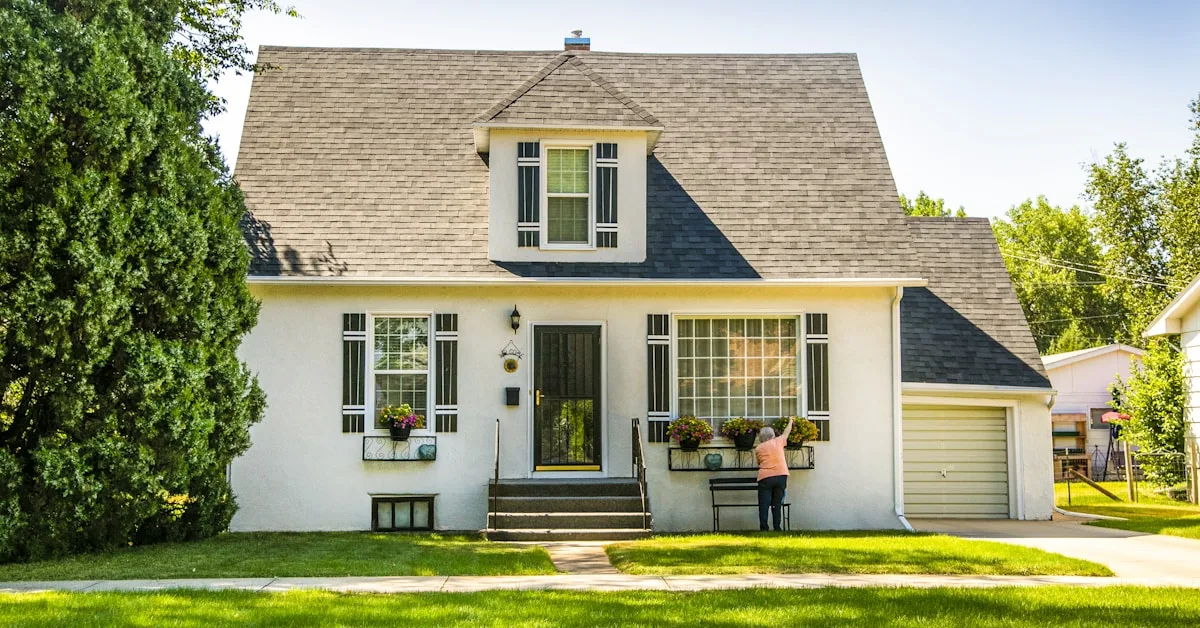 Young couple in front of their new home holding house keys