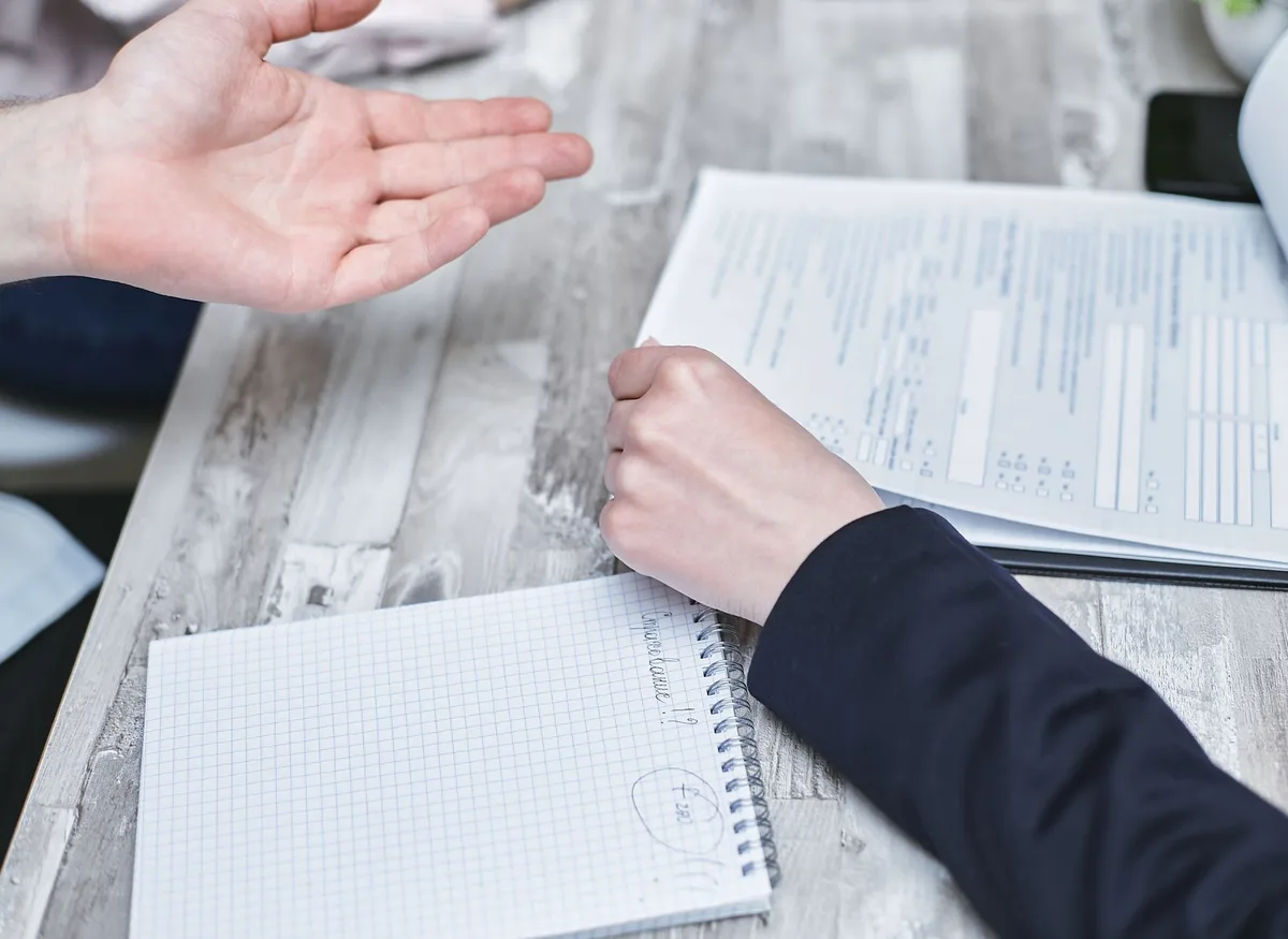 Refinancing documents and paperwork on a desk with a pen