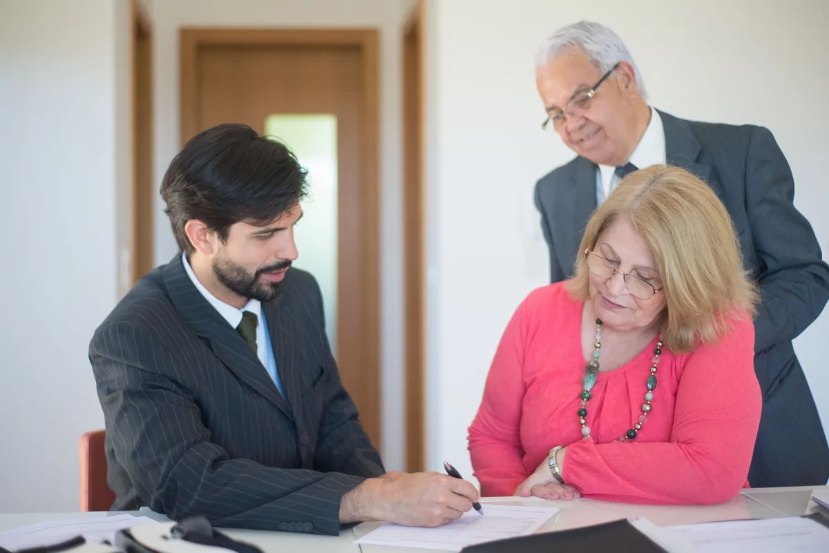 Senior couple reviewing home equity documents with financial advisor