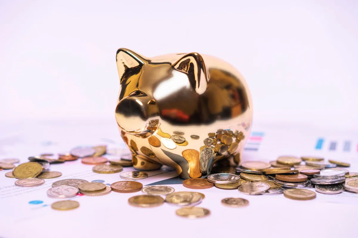 Piggy bank with coins representing savings for first home purchase