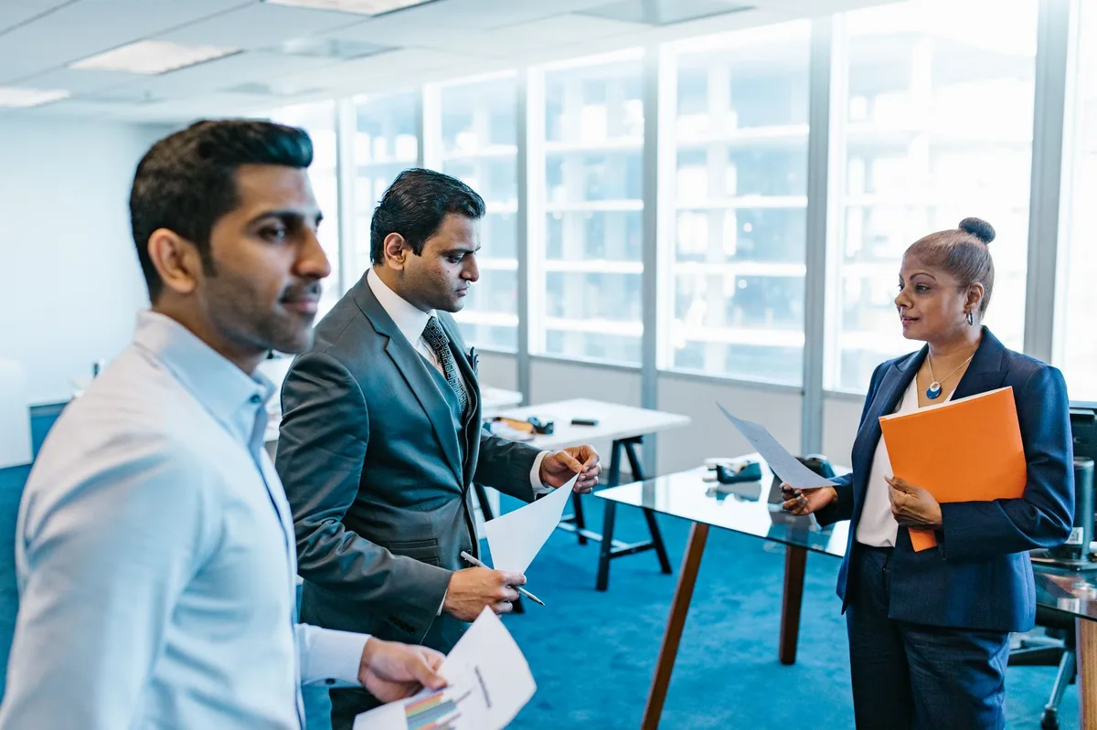 Business professionals in a meeting discussing financial documents
