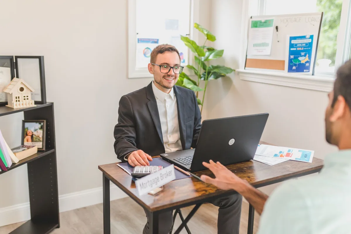 Two professionals in discussion reviewing mortgage options