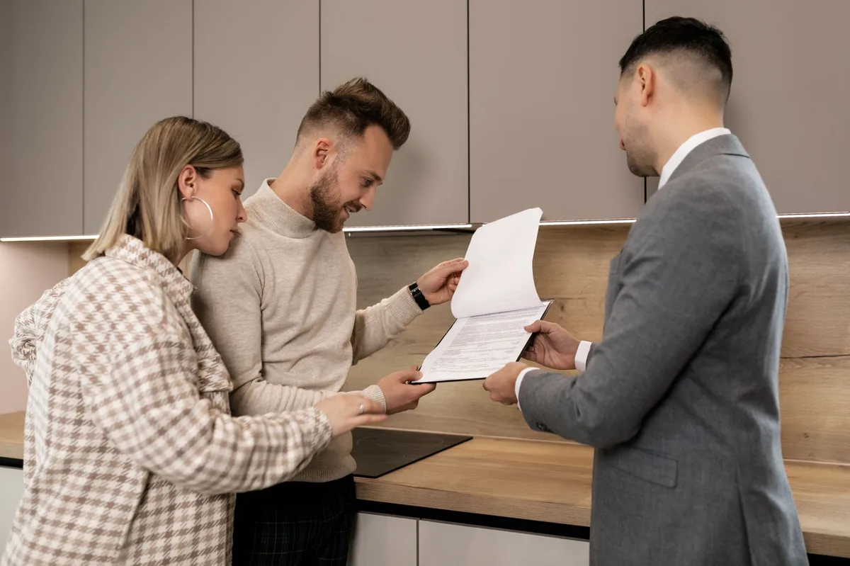 Real estate professional discussing mortgage options with clients at a desk