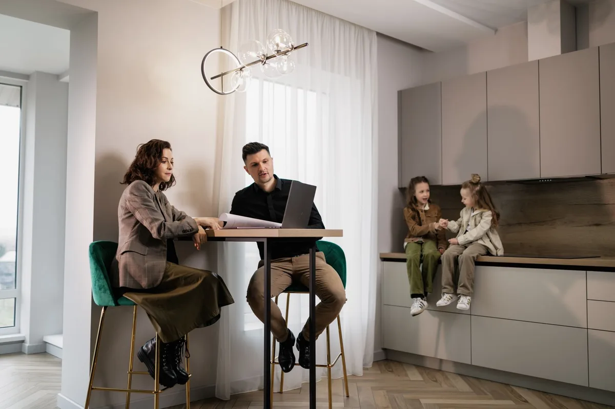 A family sitting together at a table discussing financial documents