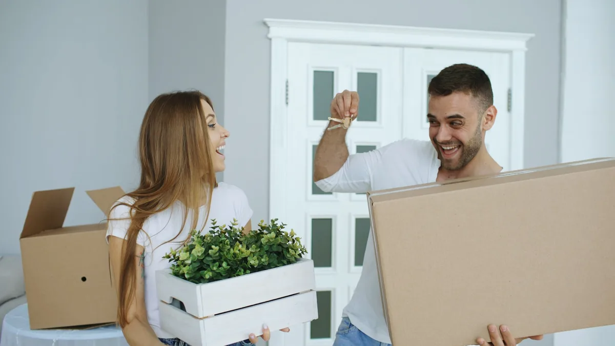 Young couple holding keys to their first home