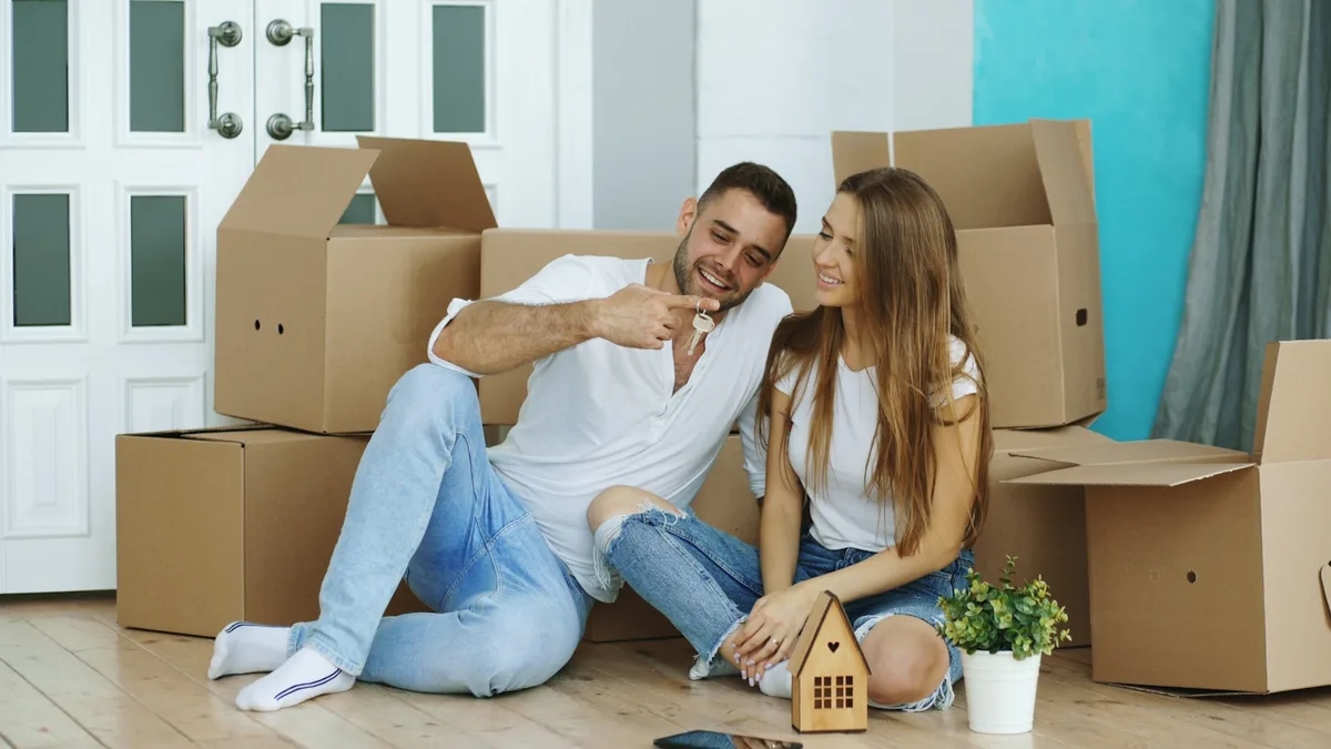 First-time buyers holding keys to their new home