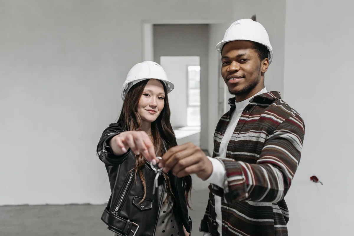 First-time home buyers celebrating in front of their new property