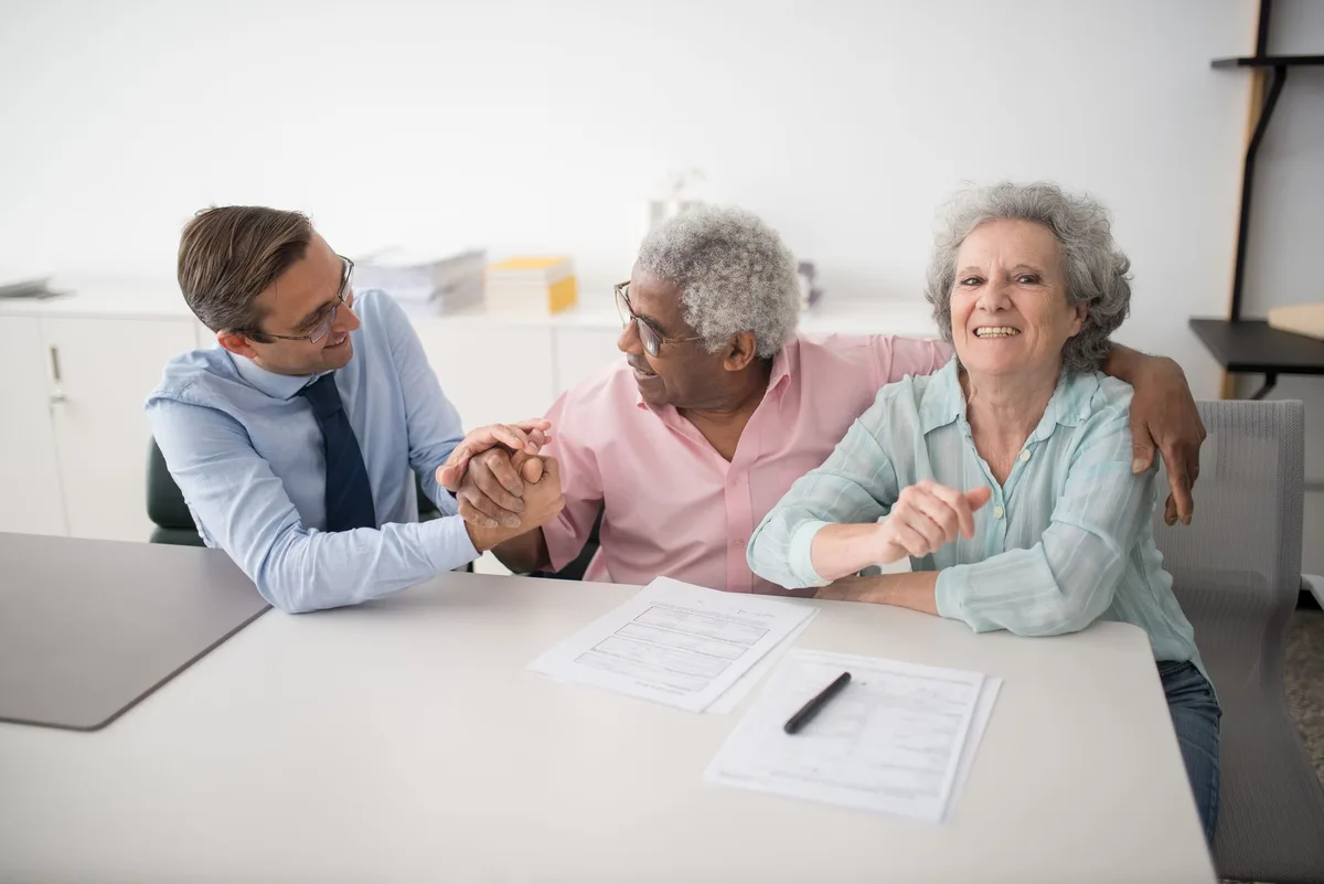 Two professionals in discussion reviewing mortgage documents
