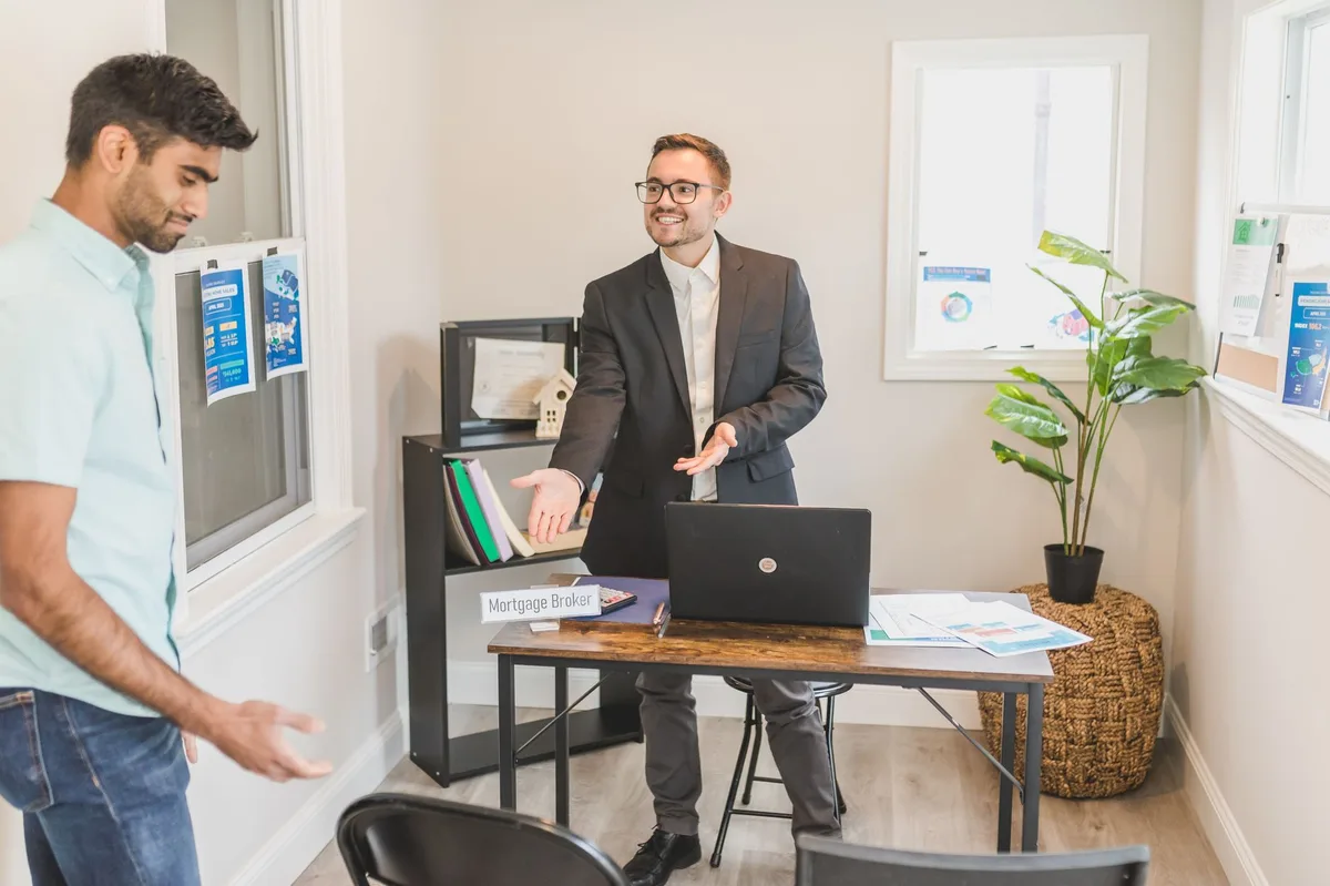 Professional mortgage adviser discussing options with clients during a consultation meeting