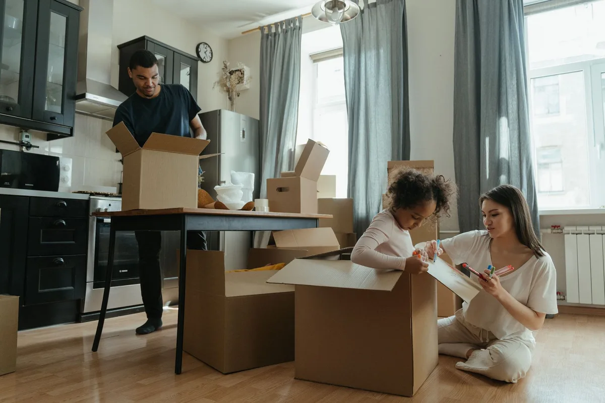 Family moving into a new home with boxes
