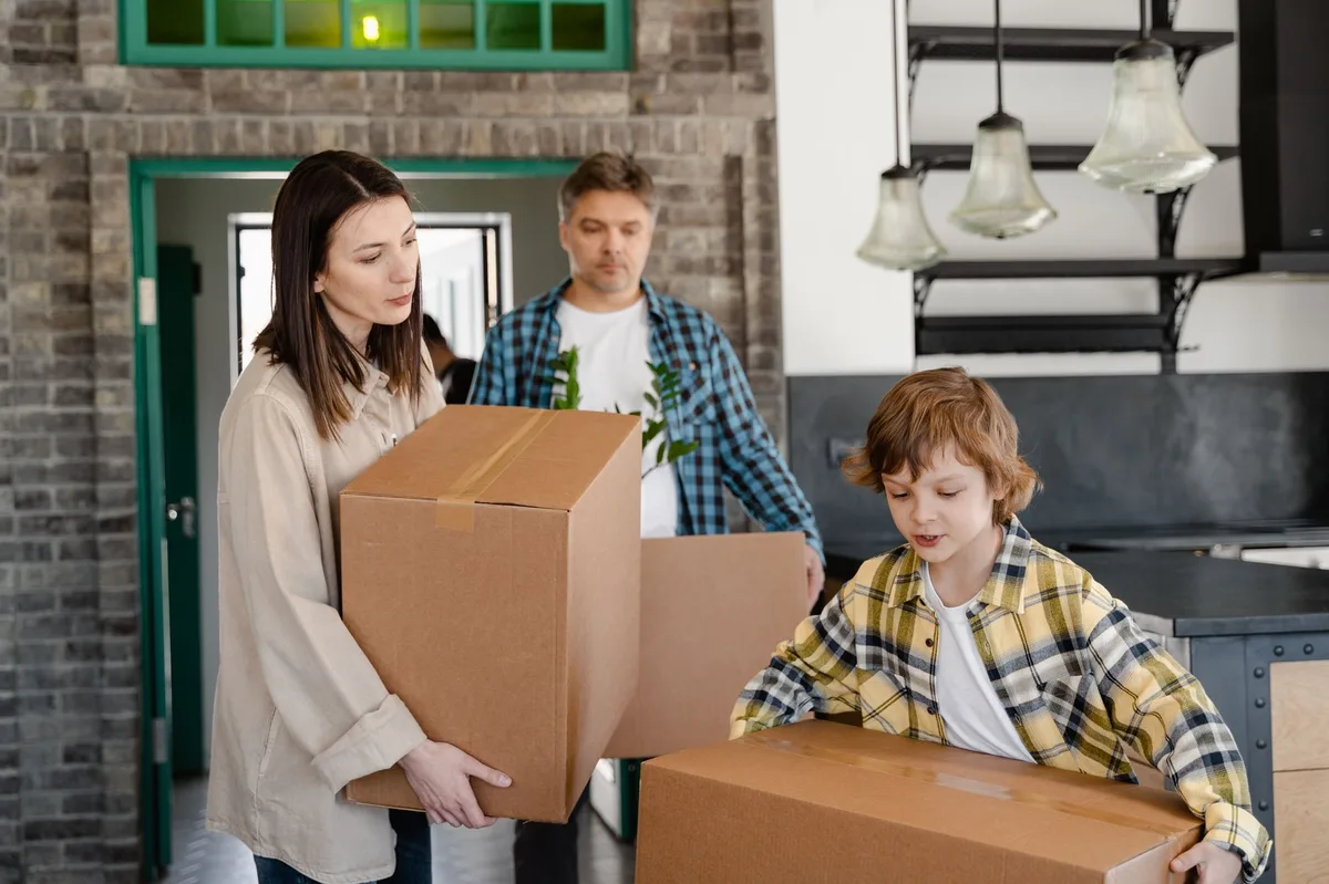 Family moving into a new home with boxes