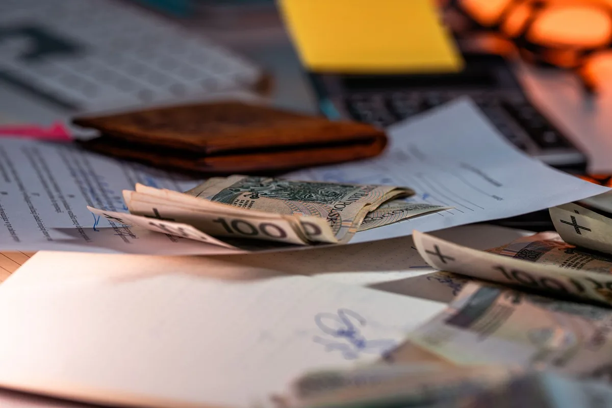 Mortgage refinance documents and calculator on a desk