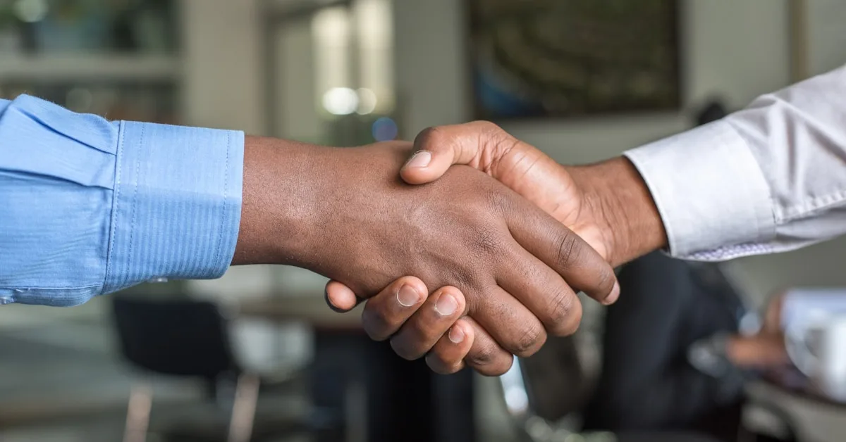 Business handshake representing financial decisions and mortgage rate agreements
