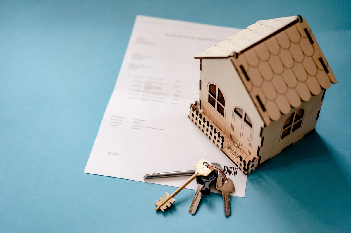 House keys and signing documents on a table representing loan decision