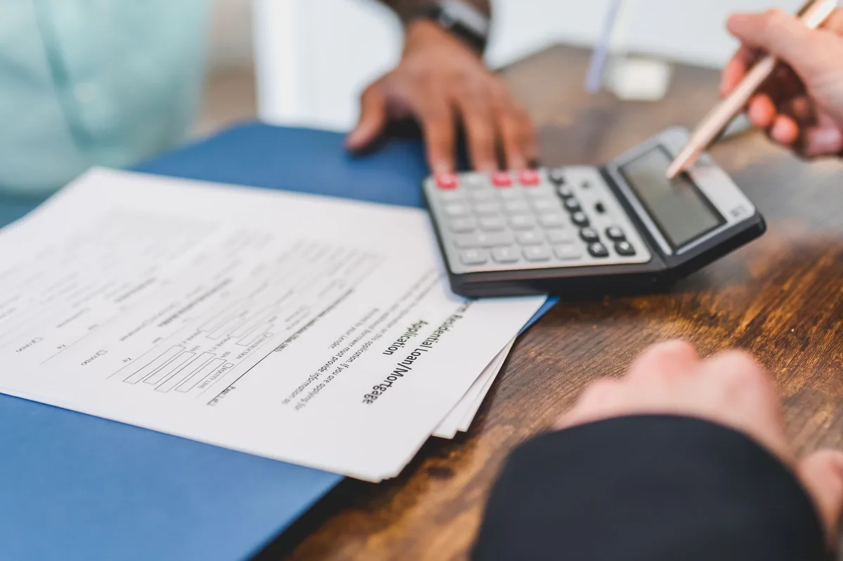 Homeowner reviewing refinancing documents at a desk