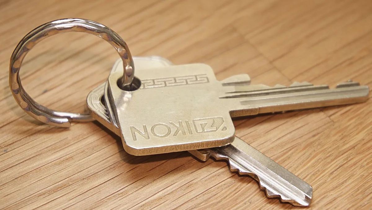 House keys on a wooden surface representing home ownership for veterans